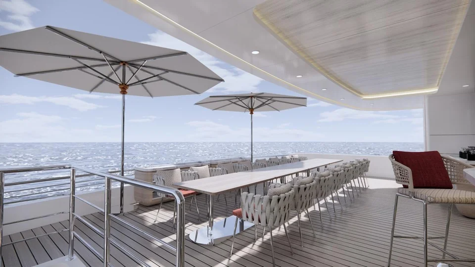 A long outdoor dining table under white parasols on the upper deck